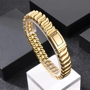 Detail of gold wave-pattern chain bracelet with polished finish on acrylic stand