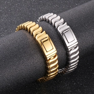 Close-up of gold and silver polished keel chain bracelets on a professional stand