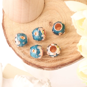 Close-up of ocean-themed blue enamel fish charms with rose gold finish and crystals