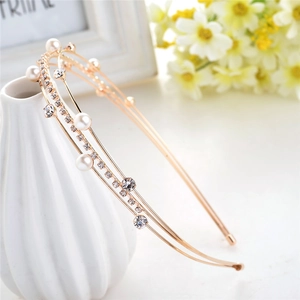 Elegant gold multi-layer headband with pearls and rhinestones shown from a side view