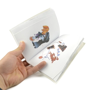 Detailed view of magic flip book with cartoon illustrations of a magician and top hat