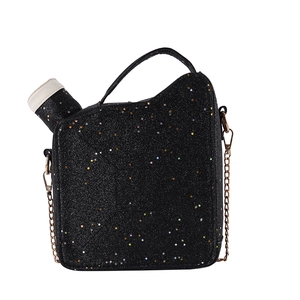 Macro detail of quirky oil can bag with black sequins, star patterns and gold chain