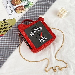 Close-up of creative red sequin oil drum handbag with gold chain and letter embroidery