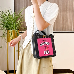 Creative oil drum shoulder bag with Bad Bitch Fuel slogan shown on a model
