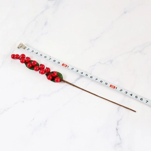Artificial red berry stems with green leaves measuring 25cm for Christmas home decor