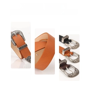 Detail view of vintage bohemian belt with carved alloy buckle and faux leather texture