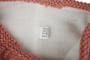 Macro detail of the fabric label showing 80% acrylic and 20% polyester material composition