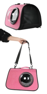 Detail view of pink pet carrier with a clear bubble window and breathable mesh side panels