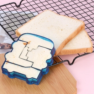 Close-up of car-shaped sandwich cutter mold on a wooden board with fresh white toast bread