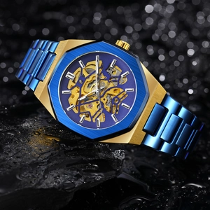 Macro shot of a luxury gold and blue skeleton watch resting on a wet dark rock