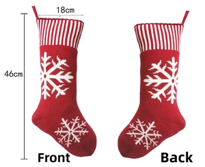 Detailed view of red knitted Christmas stockings with snowflake patterns and 46cm size specs