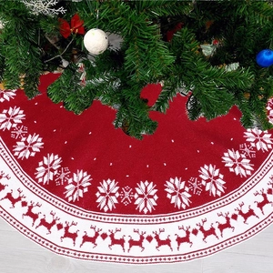 Knitted red Christmas tree skirt with white reindeer and snowflake pattern decor