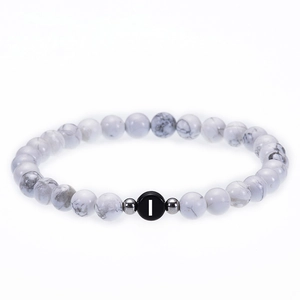 Detailed close-up of 6mm white turquoise beaded bracelet with personalized letter I bead