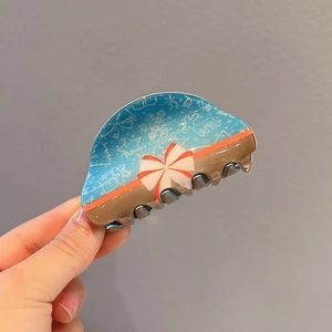 Blue Christmas hair claw clip with Merry Christmas text, bow, and snowflake details