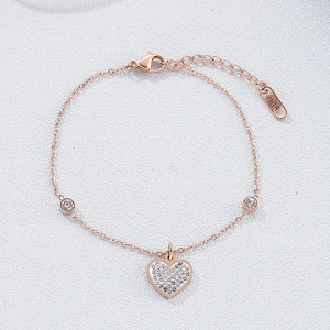 Macro shot of rose gold stainless steel heart bracelet with shimmering crystal inlay