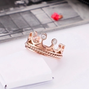 Elegant rose gold crown ring with sparkling crystals and twisted rope texture band