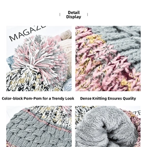 Close-up of color-block knit beanie showing pom-pom texture and thick fleece lining