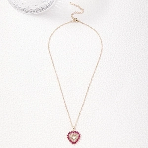 Detailed view of heart pendant necklace with pink and white cubic zirconia stones