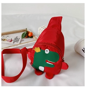 Detail of red nylon dinosaur chest bag for kids with adjustable strap and cute cartoon pattern
