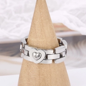 Silver stainless steel chain ring with a sparkling rhinestone heart on a wooden stand