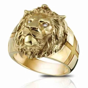 Detailed view of a gold lion head ring with white stone eyes and a polished reflection