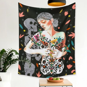 Artistic tapestry detail showing woman and floral skull design on a white wall