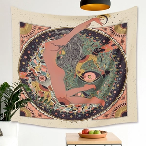 Detail of bohemian tapestry featuring mandala pattern with moon and floral silhouette