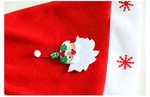 Detail of red velvet Christmas hat with Santa patch and printed snowflake pattern