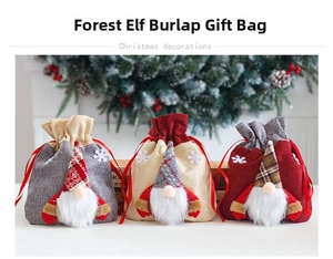 Detail of Christmas burlap gift bags featuring gnome dolls with sequins and drawstrings