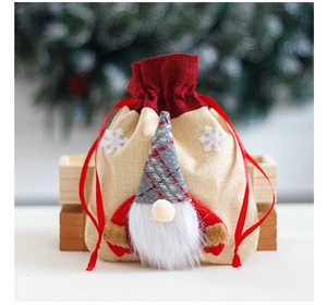 Detail of Christmas gnome drawstring burlap bag with snowflake decor and long plush beard