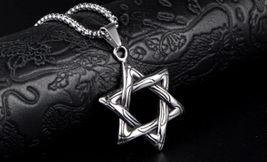 Polished silver hexagram star pendant on a box chain over a black textured surface
