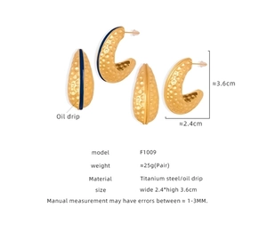 Detail view of C-shaped hammered gold earrings with blue oil drip and dimension specs
