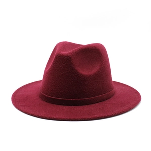 Detailed texture of a burgundy wide-brim wool fedora hat with a matching decorative band