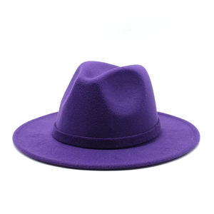 Detail of dark purple wool fedora hat featuring wide brim and matching decorative band