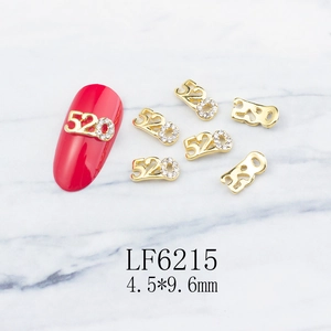 Macro view of gold 520 nail charms with rhinestones for romantic manicure decoration