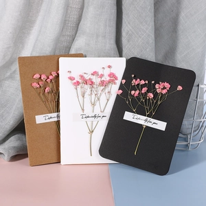 Handmade dried flower cards in brown white and black with pink floral accents