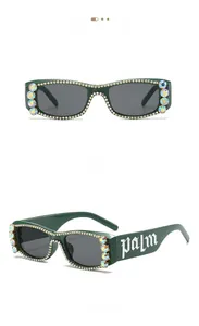 Detail of square green sunglasses with multi-color rhinestones and palm lettering on temples