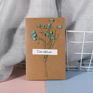 Detail of kraft paper greeting card with blue dried flowers and Especially for you text
