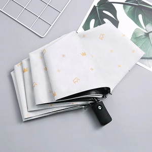 Automatic white folding umbrella with yellow crown print and black matte handle