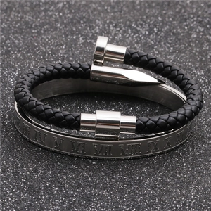 Detail of woven black leather strap with silver nail clasp and roman numeral bangle
