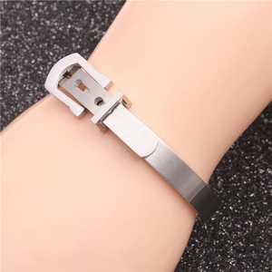 Detail of silver stainless steel woven bracelet with adjustable buckle on the model