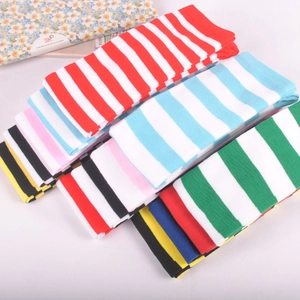 Detail of colorful striped over-the-knee socks showing various knit patterns and textures