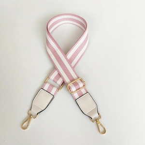 Adjustable wide canvas bag strap with pink and white stripes and gold metal hardware