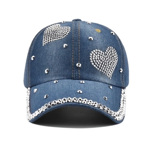 Denim baseball cap with sparkling rhinestone hearts and metal studs on deep blue wash fabric