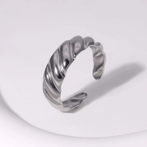 Detailed view of silver twisted croissant ring with a polished metallic finish