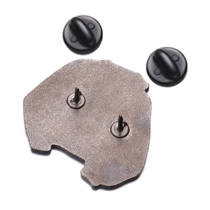 Macro detail of the metal badge back featuring a dual-pin structure and secure black rubber caps