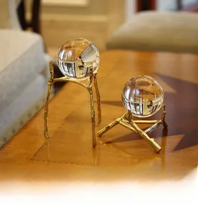 Detail of clear crystal balls on golden branch metal bases for elegant home decor