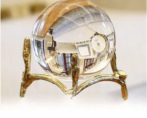 Macro shot of a crystal ball ornament with a golden branch-like artistic metal base