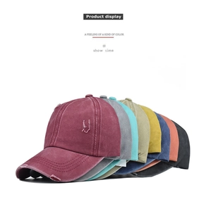 Detailed view of distressed washed cotton ponytail baseball caps in multiple colors
