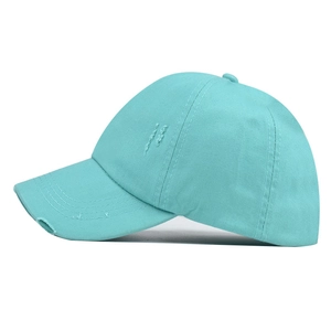 Close-up of distressed lake blue baseball cap showing washed cotton canvas texture